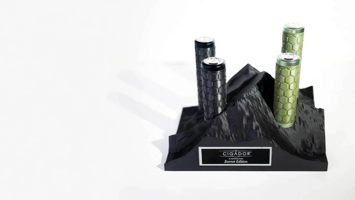 Cigador essential edition with black and green packaging on a white background