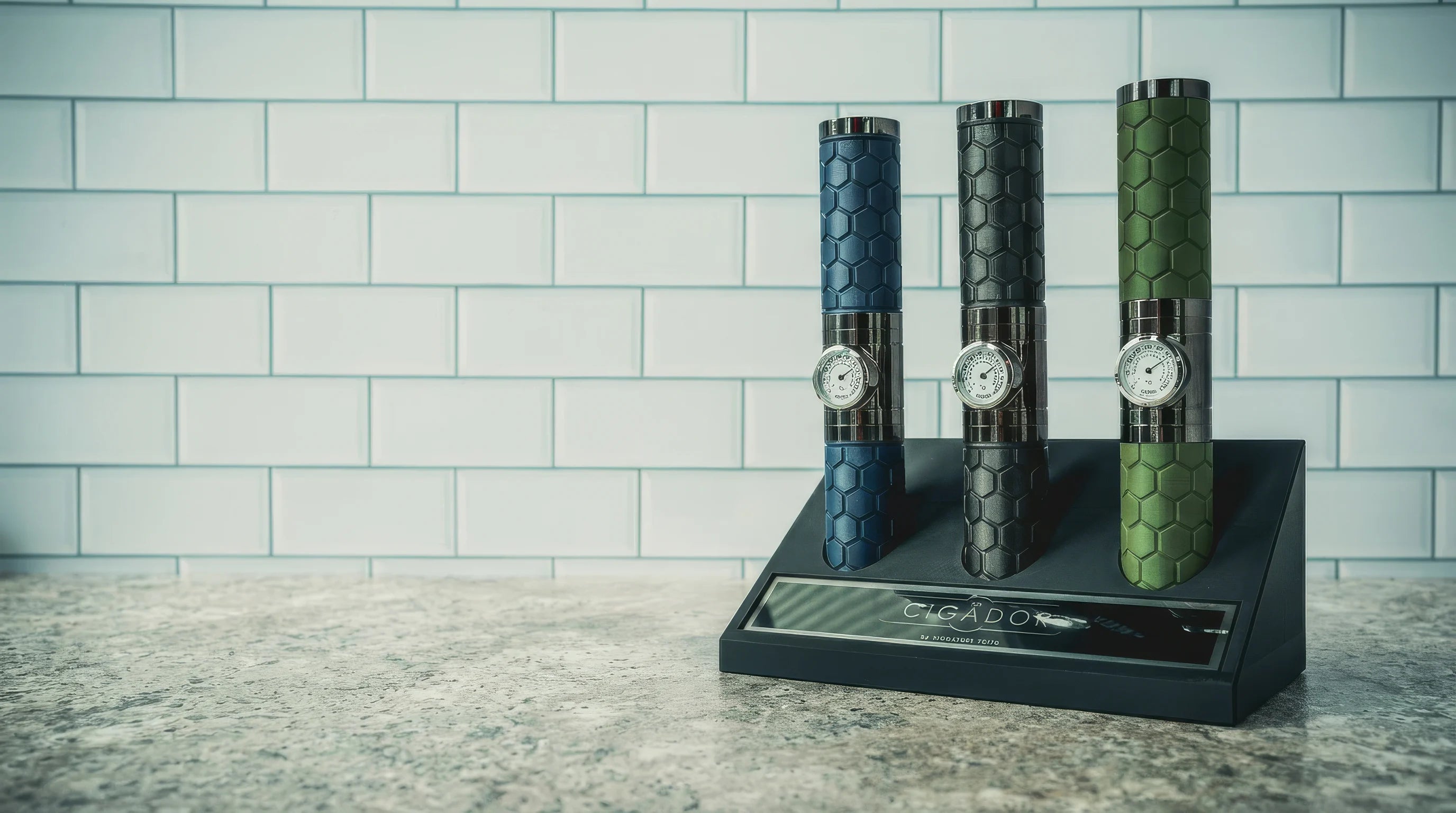Three decorative cigador with unique designs on a stand against a tiled wall.
